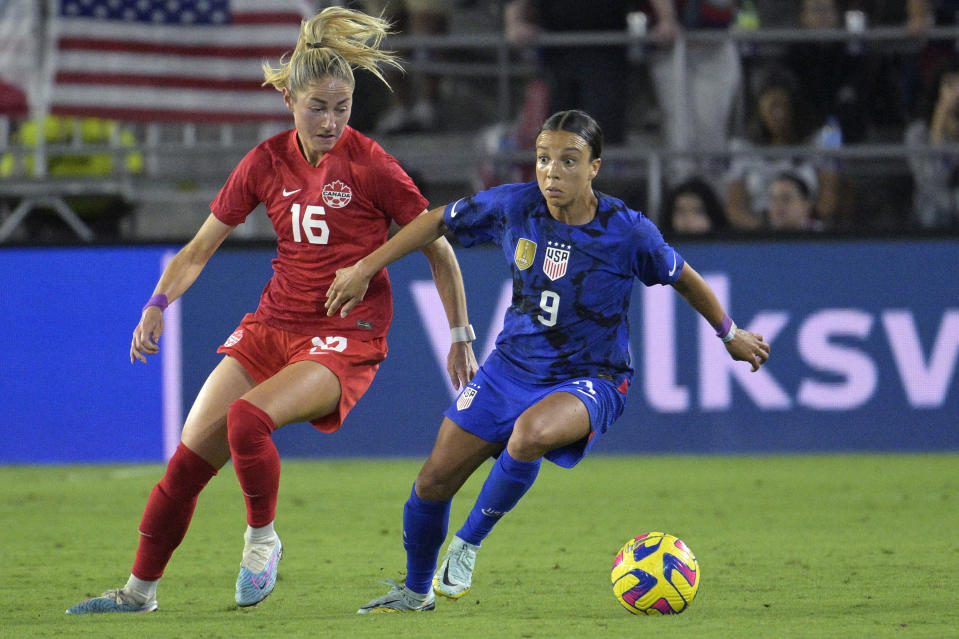 U.S. forward Mallory Swanson, right, and Canada forward Janine Beckie compete for the ball during the second half of a SheBelieves Cup women's soccer match, Thursday, Feb. 16, 2023, in Orlando, Fla. (AP Photo/Phelan M. Ebenhack)