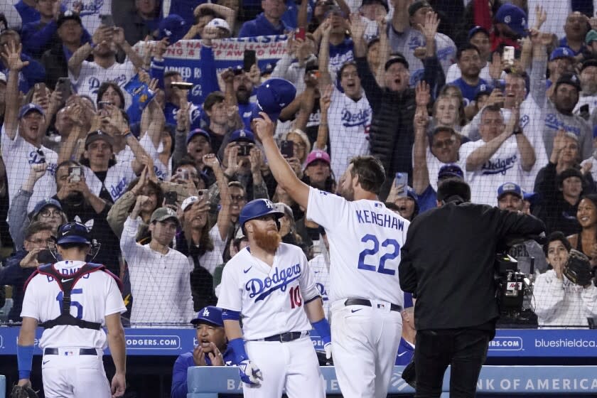 Los Angeles Dodgers starting pitcher Clayton Kershaw, right, acknowledges the fans.