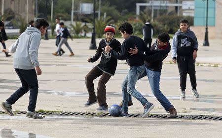 Students play soccer in front of a high school as teachers go on strike in Tunis March 2, 2015. REUTERS/Zoubeir Souissi