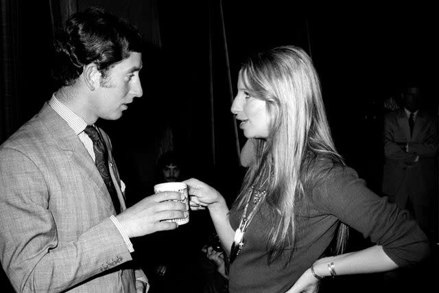 <p>Mark Sennet/Getty</p> Prince Charles and Barbra Streisand chat at Warner Bros. studio in California in 1974.