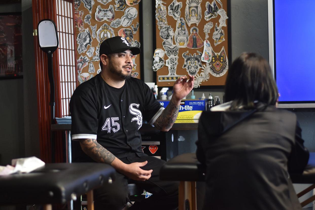 Johnny Vasquez speaking to his apprentices and tattoo artists at Spark Project Collective on Jan. 9, 2023.