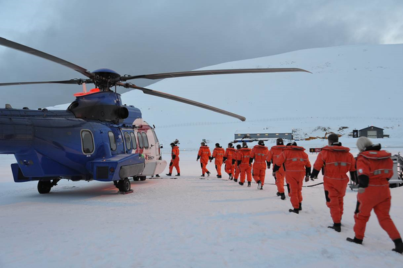 Workers lined up to board a helicopter on an icefield in Stavanger, Norway.