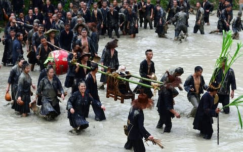 Dog Carrying Day: Behold the Chinese festival where villagers worship pooches on a throne for one day