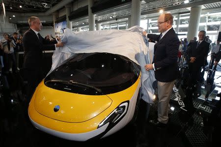 Juraj Vaculík (L), Co-Founder and Chief Executive Officer of AeroMobil, and Prince Albert II of Monaco unveil the AeroMobil flying car during the Top Marques Monaco supercar show in Monaco April 20, 2017. REUTERS/Jean-Paul Pelissier