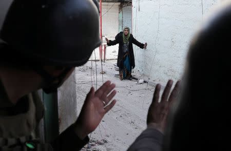 A woman gestures as she approaches Iraqi special forces soldiers during a battle in Mosul, Iraq March 1, 2017 REUTERS/Goran Tomasevic