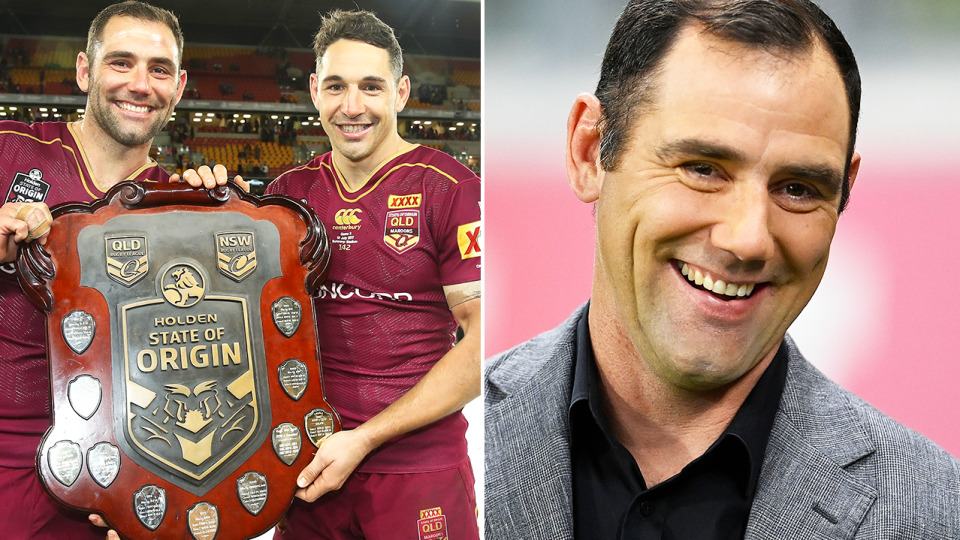 Cameron Smith and Billy Slater pose with a trophy and Smith smiles.