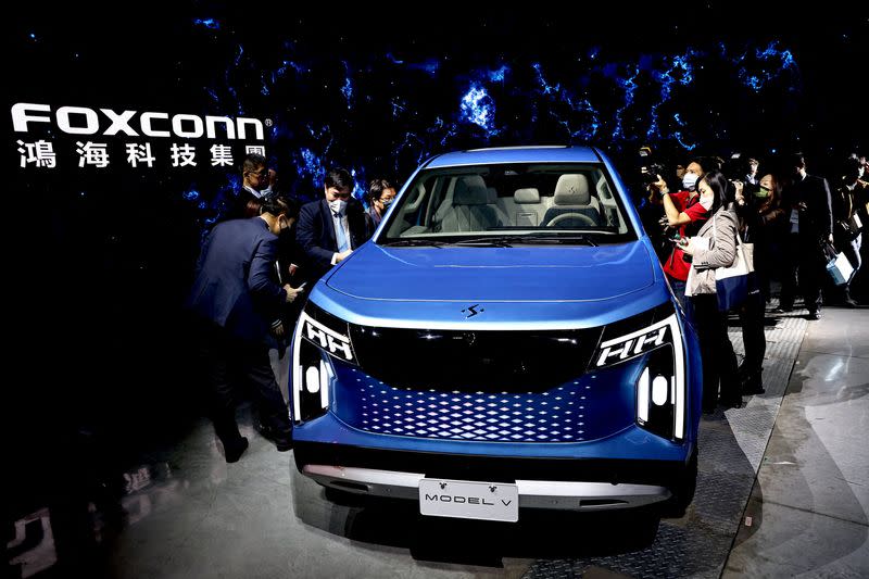 People take photos of Foxconn's new electric pickup vehicle, the Model V, during the company's annual Tech Day in Taipei