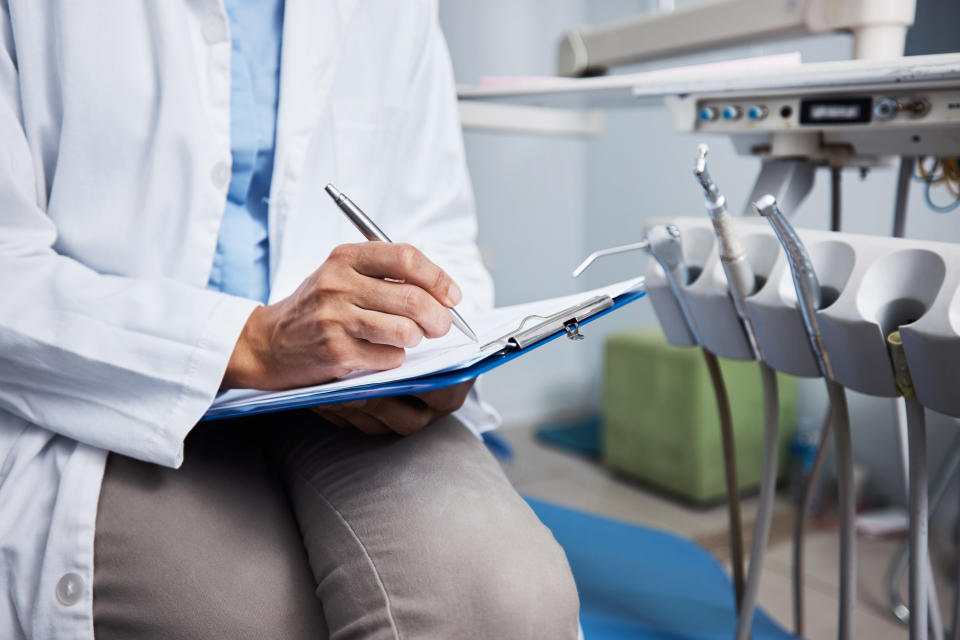 Dentist. Shot of an unrecognisable dentist writing notes on a piece of paper. Yahoo Canada gathered some expert and public opinions on dentist visits and data. (Getty)