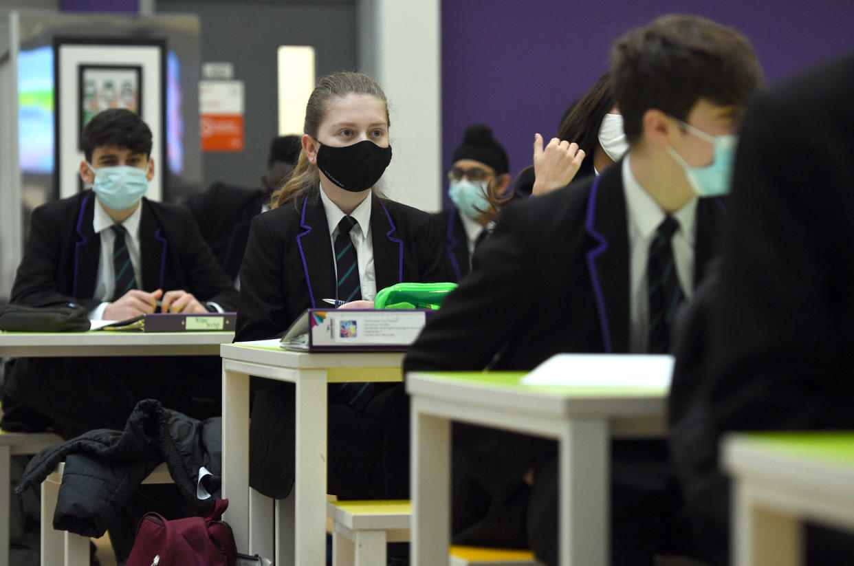 Children wearing facemasks during a lesson at Hounslow Kingsley Academy in West London, as pupils in England return to school for the first time in two months as part of the first stage of lockdown easing. Picture date: Monday March 8, 2021.