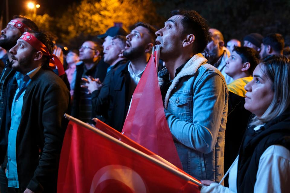 AKP supporters watch the election result on a big screen and react in front of the AKP headquarters on May 14, 2023 in Istanbul Turkey.