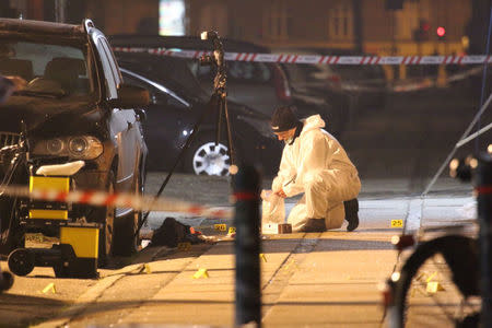 Forensic investigators are seen at the site of a shooting in Copenhagen February 14, 2015. REUTERS/Mathias Oegendal/Scanpix Denmark