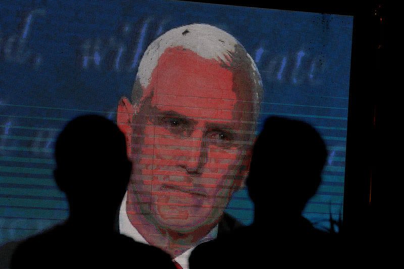 People watch the debate between U.S. Vice President Mike Pence and Democratic vice-presidential nominee Kamala Harris outside a tavern in San Diego