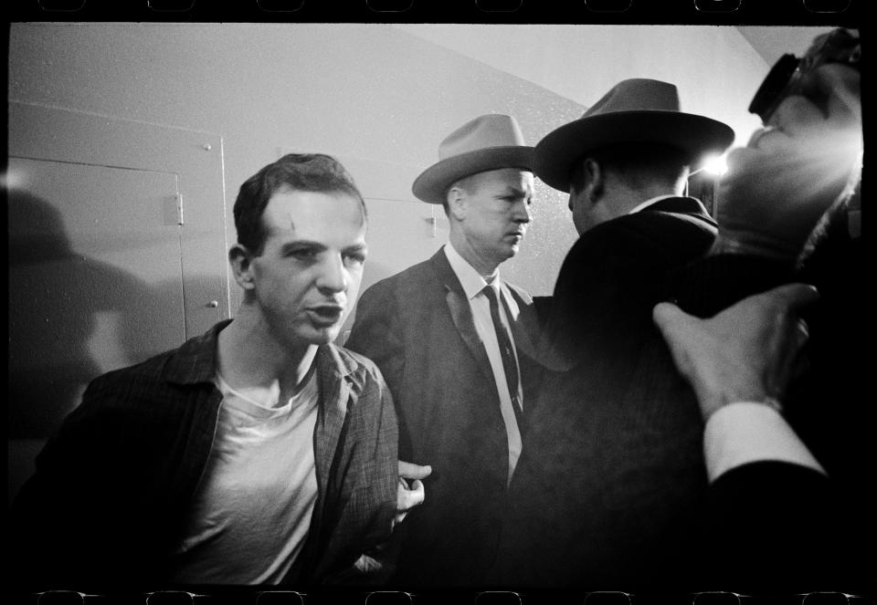 Lee Harvey Oswald in the Dallas Police Department on Nov. 23, 1963 after the assassination of John F. Kennedy. - Credit: Photo by Lawrence Schiller/Courtesy