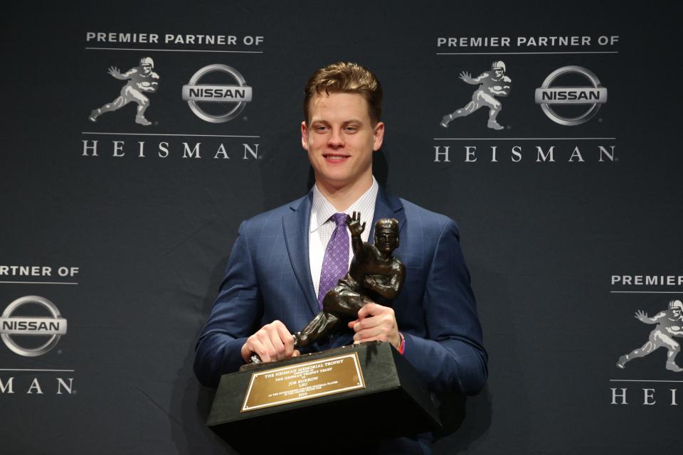 Heisman Trophy winner Joe Burrow poses with the trophy during a post-ceremony press conference at the New York Marriott Marquis, Dec. 14, 2019.