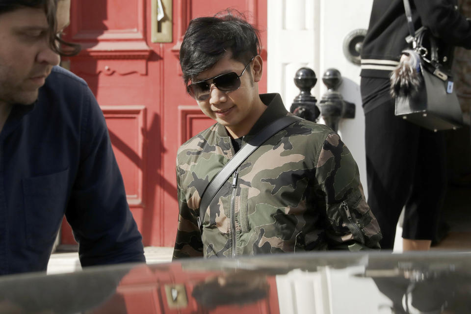 FILE - In this April 5, 2017, file photo, Vorayuth "Boss" Yoovidhya, whose grandfather co-founded energy drink company Red Bull, walks to get in a car as he leaves a house in London. Charges have been dropped against the Thai heir to the Red Bull energy drink fortune who is accused in a 2012 car crash that killed a Bangkok police officer, Thai police said Friday, July 24, 2020. (AP Photo/Matt Dunham, File)