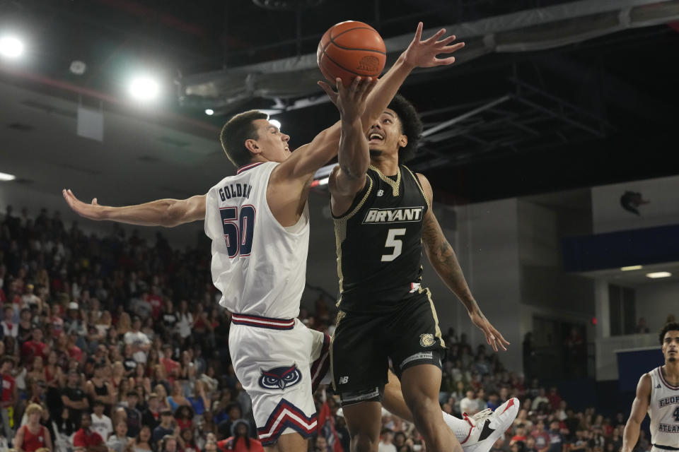 Bryant University forward Daniel Rivera (5) aims to score as Florida Atlantic center Vladislav Goldin (50) defends during the first half of an NCAA college basketball game, Saturday, Nov. 18, 2023, in Boca Raton, Fla. (AP Photo/Marta Lavandier)