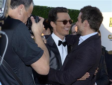 Actors Matthew McConaughey and Bradley Cooper (R) embrace as they arrive at the 19th annual Critics' Choice Movie Awards in Santa Monica, California January 16, 2014. REUTERS/Kevork Djansezian