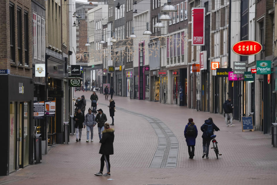 All non-essential stores remain closed and only a few people are seen in the center of Nijmegen, Netherlands, Friday, Jan. 14, 2022. The Netherlands are facing growing anger at weeks of coronavirus lockdown measures, a day before some of the restrictions are expected to be eased. (AP Photo/Peter Dejong)