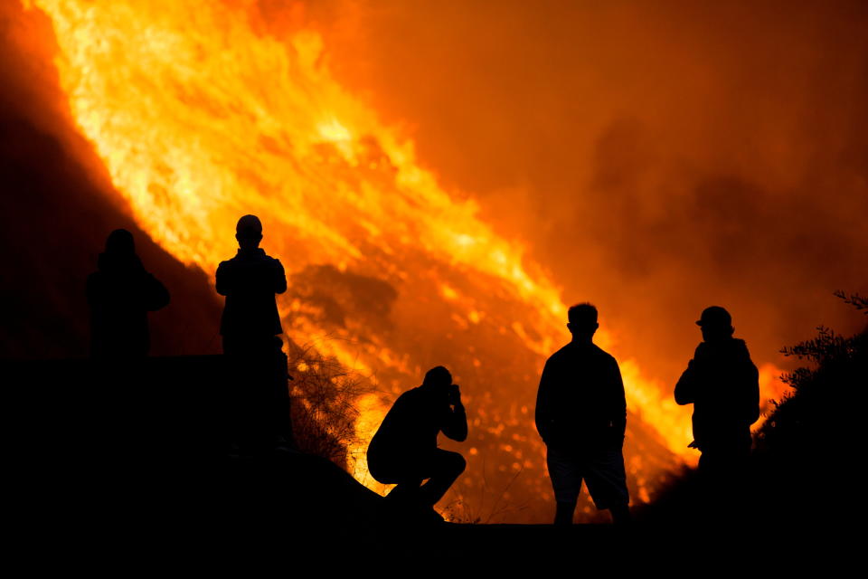 Residents are silhouetted as they watch the Blue Ridge Fire burning in Yorba Linda, California, U.S. October 26, 2020. REUTERS/Ringo Chiu     TPX IMAGES OF THE DAY