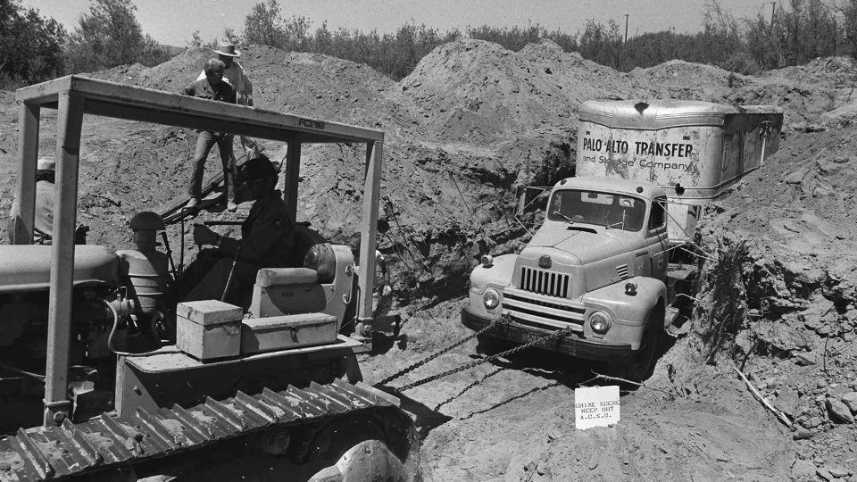 Officials remove the buried truck from a rock quarry in Livermore, California, on July 20, 1976. - AP