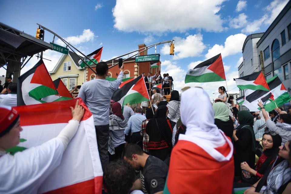 Participants are seen with Palestinian flags during a ceremony to rename part of Main Street to Palestine Way, Sunday  in Paterson on 05/15/22.