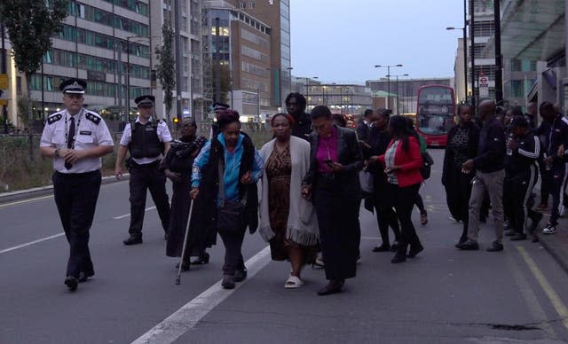 A church leader on behalf of the family arrives to read out a statement near the scene in Croydon, south London, where 15-year-old Elianne Andam was stabbed to death on Wednesday morning.