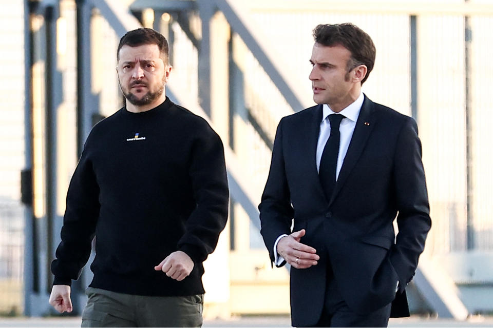 French President Emmanuel Macron, right, walks next to Ukraine's President Volodymyr Zelenskyy before heading to Brussels, in Military Airport Villacoublay, in Velizy-Villacoublay, Southwest of Paris, France, Thursday, Feb. 9, 2023. French President Macron and Ukrainian president Zelenskyy and traveling together to Brussels to take a part in a summit of European Union leaders. (Mohammed Badra / Pool Photo via AP)