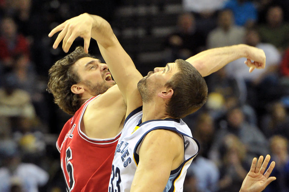 FILE - In this Dec. 19, 2014, file photo, Chicago Bulls forward Pau Gasol, left, and his brother Memphis Grizzlies center Marc Gasol vie for a jump ball at the start of an NBA basketball game in Memphis, Tenn. Pau and Marc Gasol will make history Sunday, Feb. 15, 2015, when the Spanish centers become the first brothers to start against each other in the NBA All-Star game. (AP Photo/Brandon Dill, File)