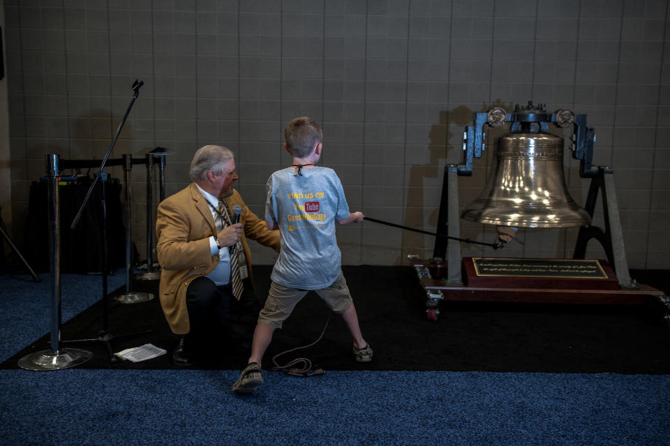 A young boy yells, "Let freedom ring," as he rings a replica of the Liberty Bell on the expo floor on&nbsp;Sunday.