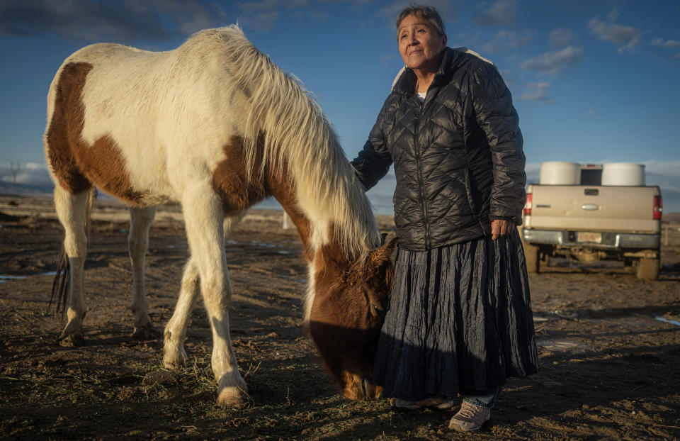 Help-Hood with her horse in Tohlakai, N.M.  (Sharon Chischilly for NBC News)