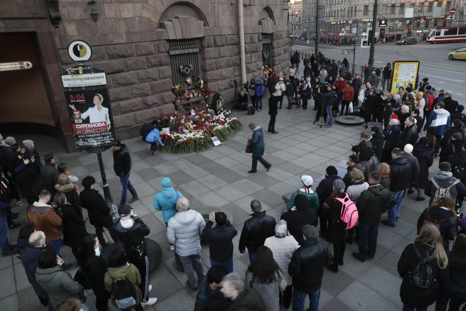 People gather at a symbolic memorial at Technologicheskiy Institute subway station in St. Petersburg, Russia, Tuesday, April 4, 2017. A bomb blast tore through a subway train deep under Russia's second-largest city St. Petersburg Monday, killing several people and wounding many more in a chaotic scene that left victims sprawled on a smoky platform. (AP Photo/Dmitri Lovetsky)