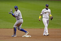 Kansas City Royals' Salvador Perez, left, reacts after hitting a two-RBI double during the first inning of a baseball game against the Milwaukee Brewers, Friday, Sept. 18, 2020, in Milwaukee. (AP Photo/Aaron Gash)