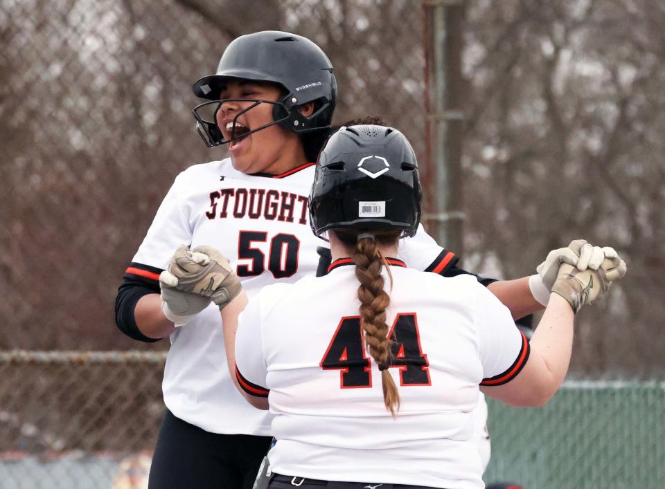 Stoughton's Alyssa Edwards, left, jumps for joy after hitting a home run versus Brockton during a game on Friday, March 31, 2023.