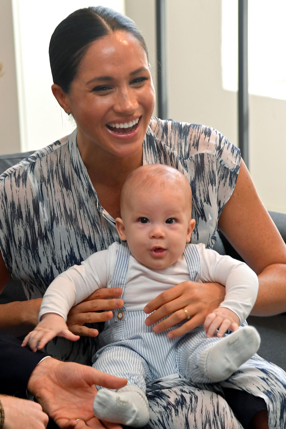 Archie was adorably cuddled by his parents during the meeting. Photo: Reuters