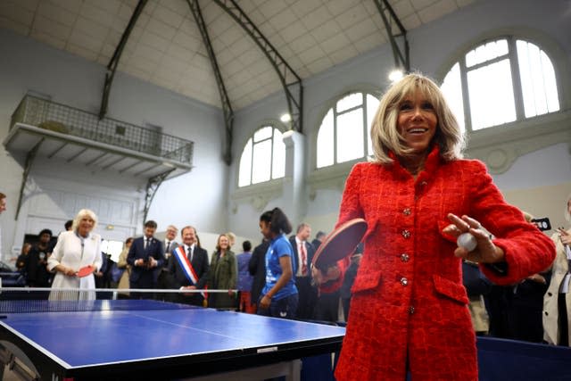The Queen plays table tennis with Brigitte Macron