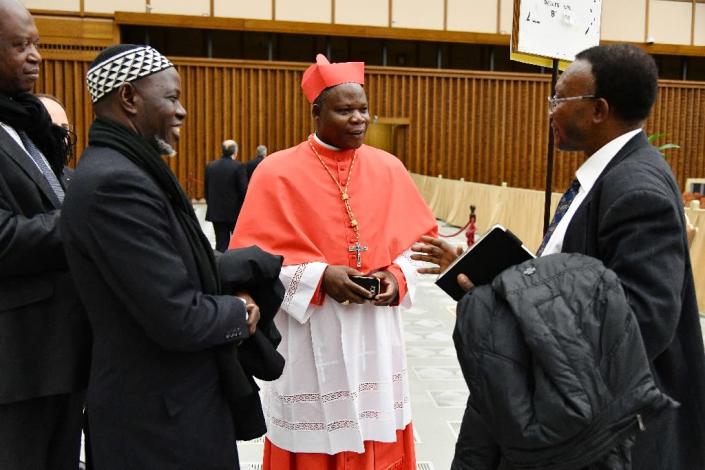 Newly elevated cardinal, Archbishop of Bangui, Dieudonne Nzapalainga, speaks with relatives during a courtesy visit following a consistory on November 19, 2016 at the Paul VI audience hall in Vatican (AFP Photo/Vincenzo Pinto)