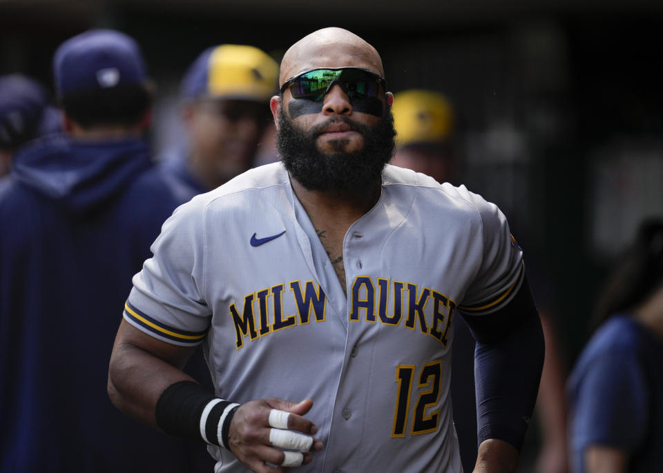 Milwaukee Brewers' Jon Singleton (12) jogs through the dugout prior to a baseball game against the Cincinnati Reds in Cincinnati, Saturday, June 3, 2023. (AP Photo/Jeff Dean)