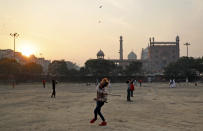 <p>An boy plays in front of Jama Masjid mosque as the sun sets in the old parts of New Delhi, India, Wednesday, Jan. 16, 2019. Old Delhi, founded by Mughal Emperor Shah Jahan in the 17th Century, is today a dilapidated version of its former glory when it was the capital city of the Mughals and filled with mosques, gardens, mansions of nobles and members of the royal court. Despite being extremely crowded and dilapidated, it still serves as the symbolic heart of the city. (AP Photo/Altaf Qadri) </p>