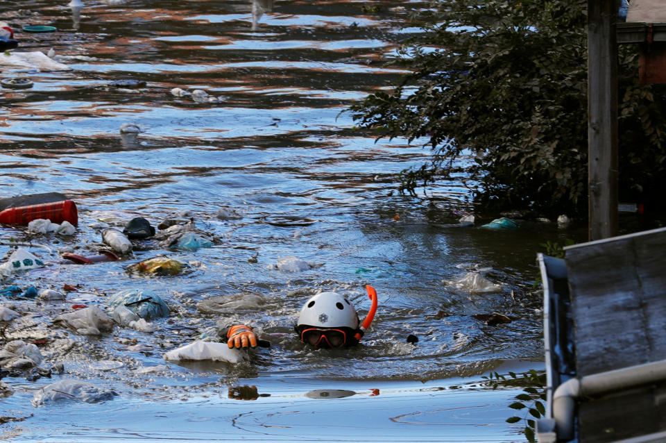 A rescue worker swims as he checks around a flooded residential area due to Typhoon Hagibis, in Kawasaki, Japan, Oct.13, 2019. (Photo: Kim Kyung Hoon/Reuters)