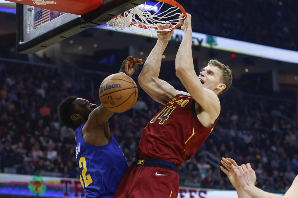 FILE - Cleveland Cavaliers' Lauri Markkanen (24) dunks against Denver Nuggets' Jeff Green, left, during the first half of an NBA basketball game, Friday, March 18, 2022, in Cleveland. Cleveland made its acquisition of All-Star guard Donovan Mitchell in a trade with Utah official on Saturday, Sept. 3. Cleveland sent guard Collin Sexton, guard Lauri Markkanen and rookie guard Ochai Agbaji to Utah along with unprotected first-round draft picks in 2025, 2027 and 2029.(AP Photo/Ron Schwane, File)