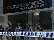 Police stand guard the entrance of Dr. Leopoldo Luque's practice in Buenos Aires, Argentina, Sunday, Nov. 29, 2020. Luque was Diego Maradona's personal doctor, and his house and offices were raided Sunday in the midst of investigations to establish the circumstances of the death of the former soccer star. (AP Photo/Leo La Valle)