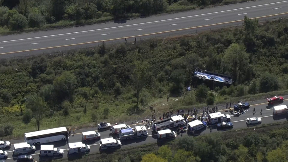 Emergency responders work the scene of a fatal bus crash, in Wawayanda, N.Y., Thursday, Sept. 21, 2023. The charter bus carrying high school students to a band camp hurtled off a New York highway and down an embankment, officials said. (NBC New York via AP)