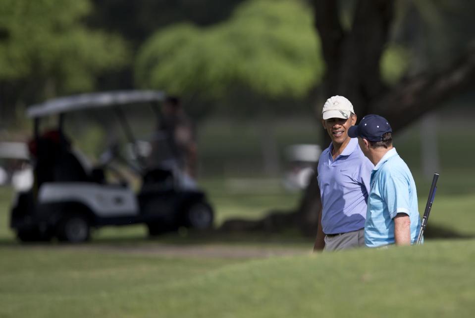 President Barack Obama walks with New Zealand Prime Minister John Key to the second green as they golf at Kaneohe Klipper Golf Course on Marine Corps Base Hawaii in Kaneohe Bay, Hawaii, Thursday, Jan. 2, 2014. The first family is in Hawaii for their annual holiday vacation. (AP Photo/Carolyn Kaster)