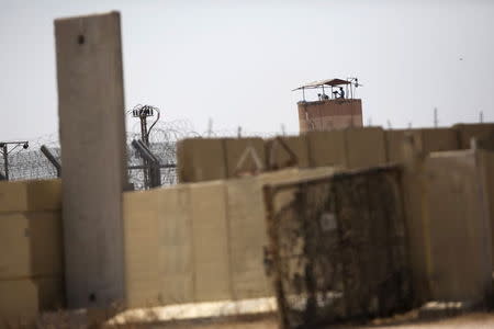A member of Egypt's security forces stands on a watchtower in North Sinai as seen from across the border in southern Israel July 2, 2015. REUTERS/Amir Cohen