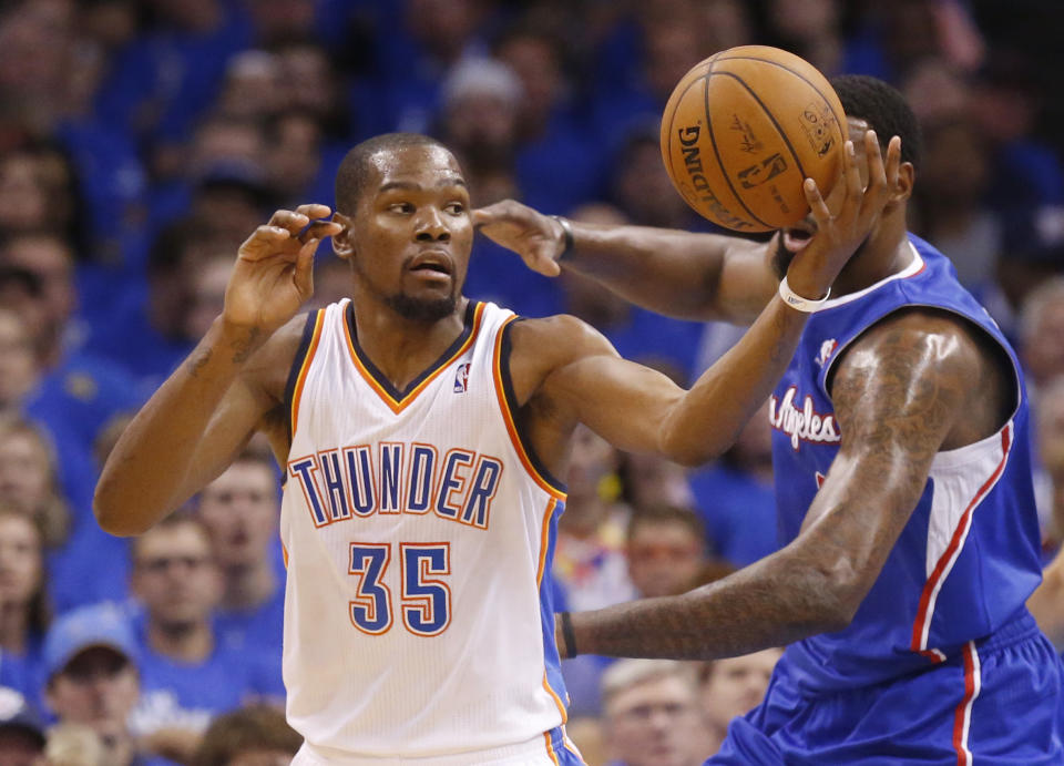 Oklahoma City Thunder forward Kevin Durant (35) reaches for the ball in the first quarter of Game 2 of the Western Conference semifinal NBA basketball playoff series against the Los Angeles Clippers in Oklahoma City, Wednesday, May 7, 2014. (AP Photo/Sue Ogrocki)