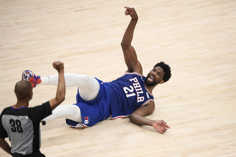 Philadelphia 76ers center Joel Embiid (21) reacts toward referee Michael Smith (38) after he was fouled by Washington Wizards center Alex Len during the first half of Game 3 in a first-round NBA basketball playoff series, Saturday, May 29, 2021, in Washington. (AP Photo/Nick Wass)