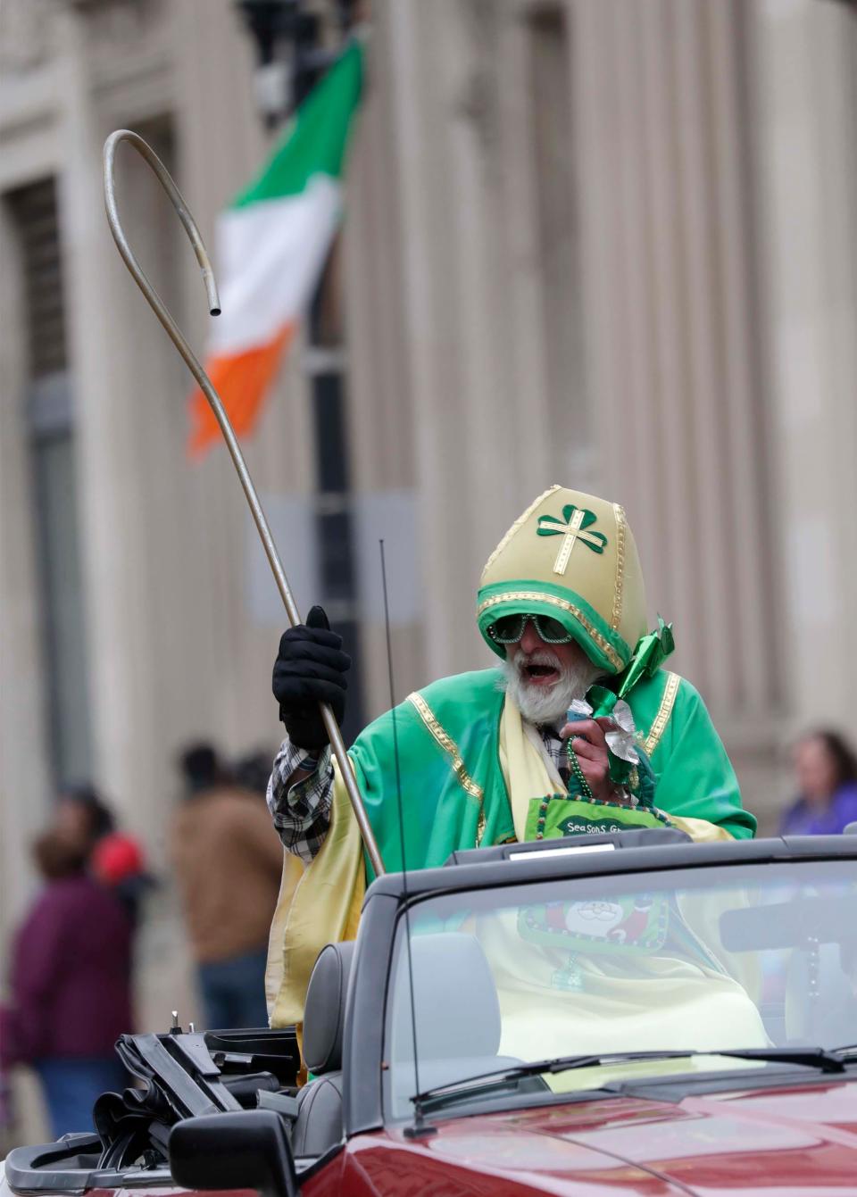 St. Patrick, portrayed by Tom Drill, rides in the St. Patrick's Day parade, Saturday, March 14, 2020, in Manitowoc, Wis.