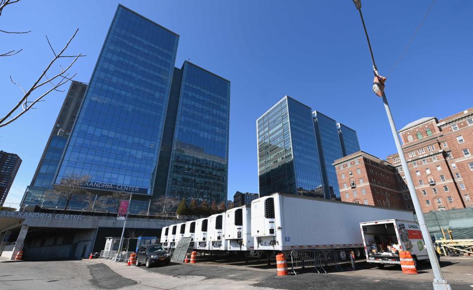 Refrigeration trucks are in place as workers build a makeshift morgue outside of Bellevue Hospital to handle an expected surge in coronavirus deaths.