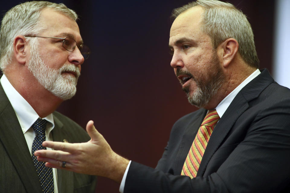 State Sens. Ben Albritton, R-Wauchula and. Joe Gruters, R-Sarasota confer during debate on Senate Bill 4B - Statewide Prosecutor, Wednesday, Feb. 8, 2023 at the Capitol in Tallahassee, Fla. (AP Photo/Phil Sears)