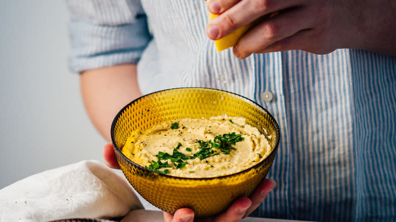 Man preparing fresh hummus 